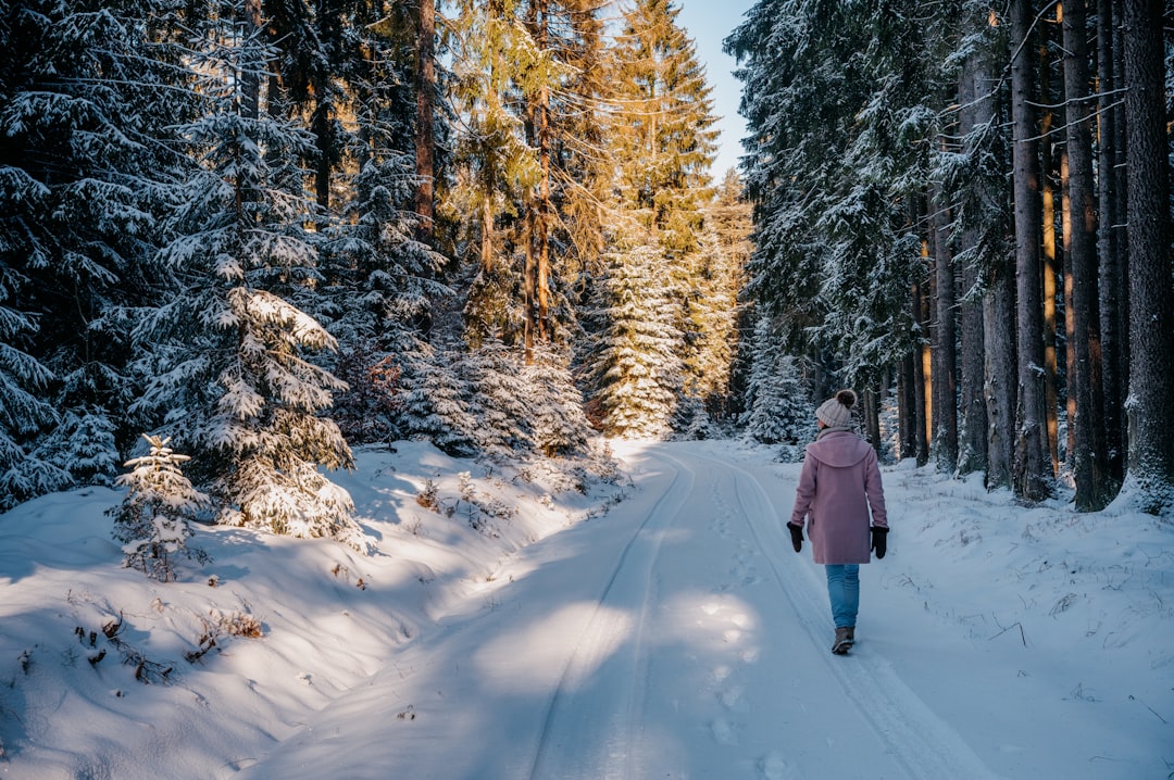 portfolio-03 a-woman-walking-down-a-snow-covered-road-lke9rhxdcac